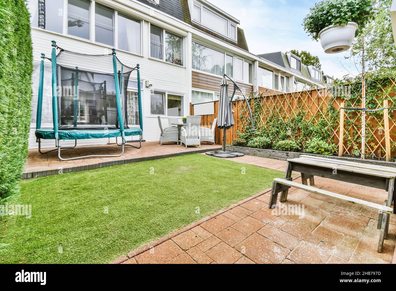 Small but cozy courtyard of the house with fresh lawn and wooden ...