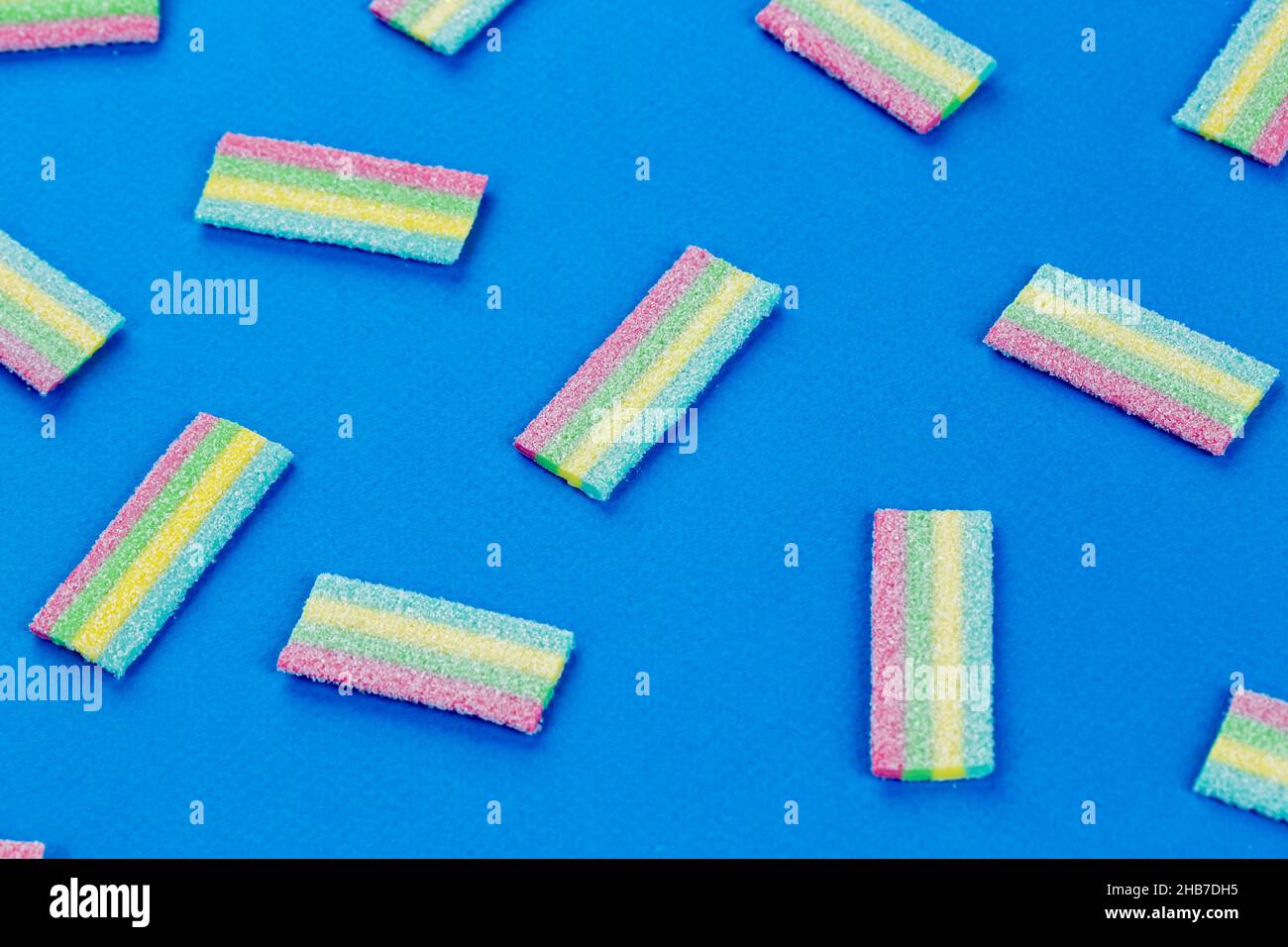 Licorice Candy. Sweet gummy sticks with different flavor, on blue