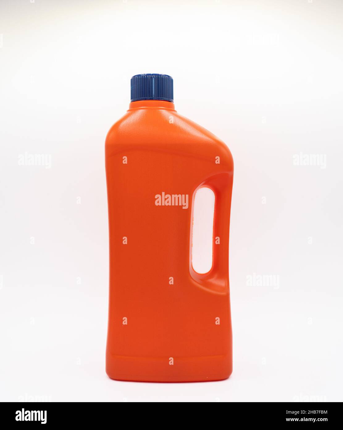 orange plastic bottle with blue cap for household chemicals Stock Photo