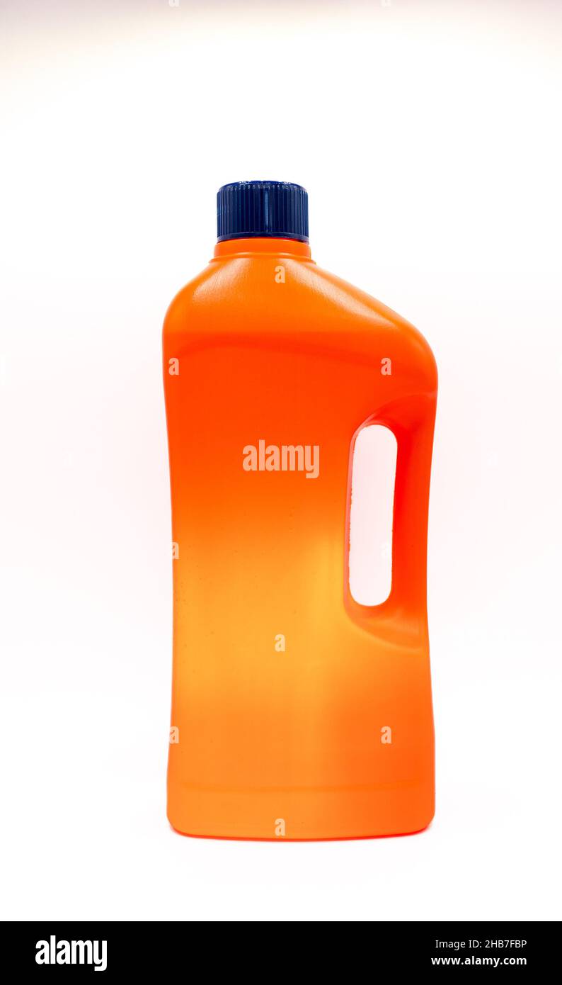 orange plastic bottle with blue cap for household chemicals Stock Photo