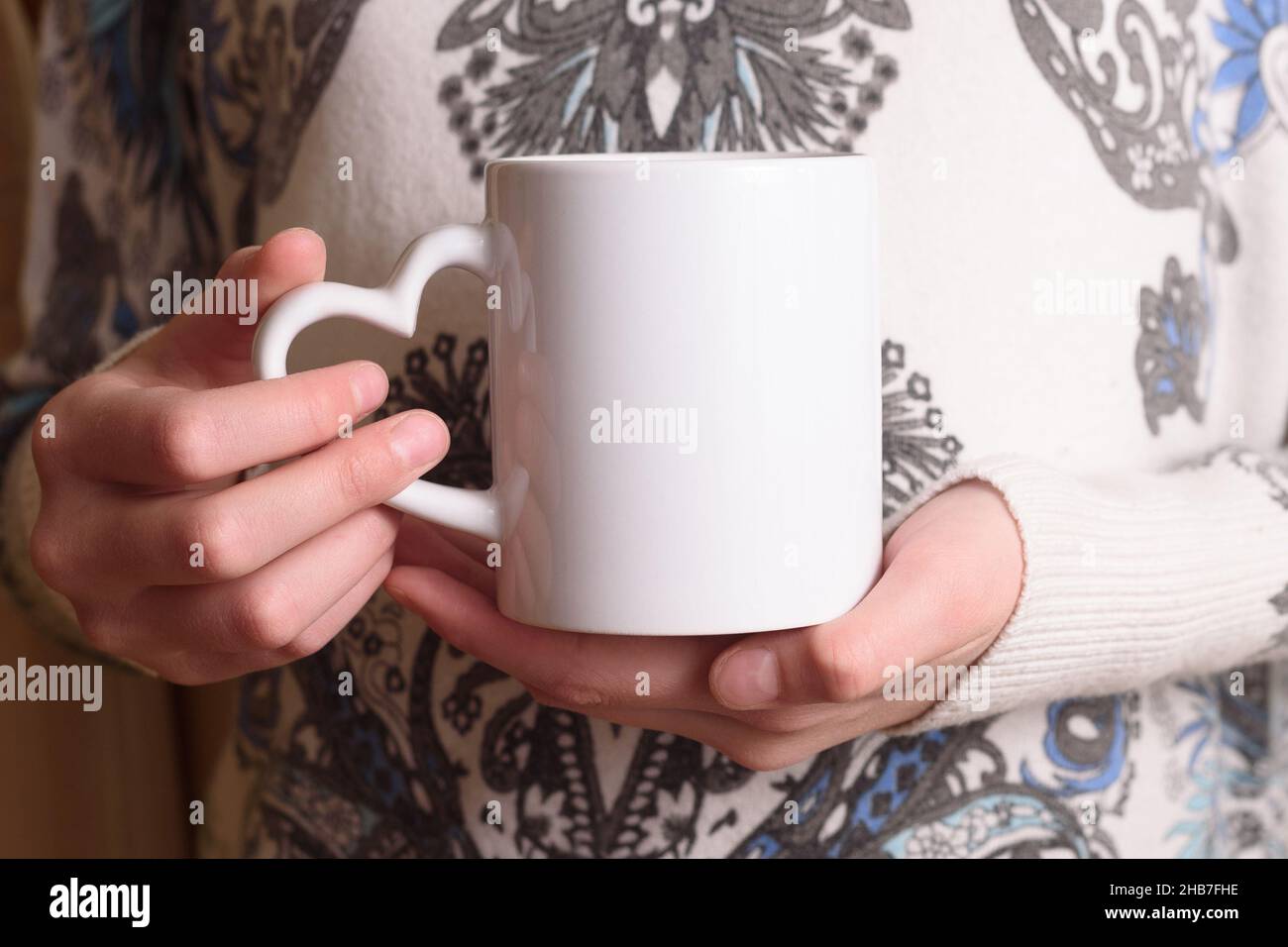 Female hands holding a white mug mockup Stock Photo