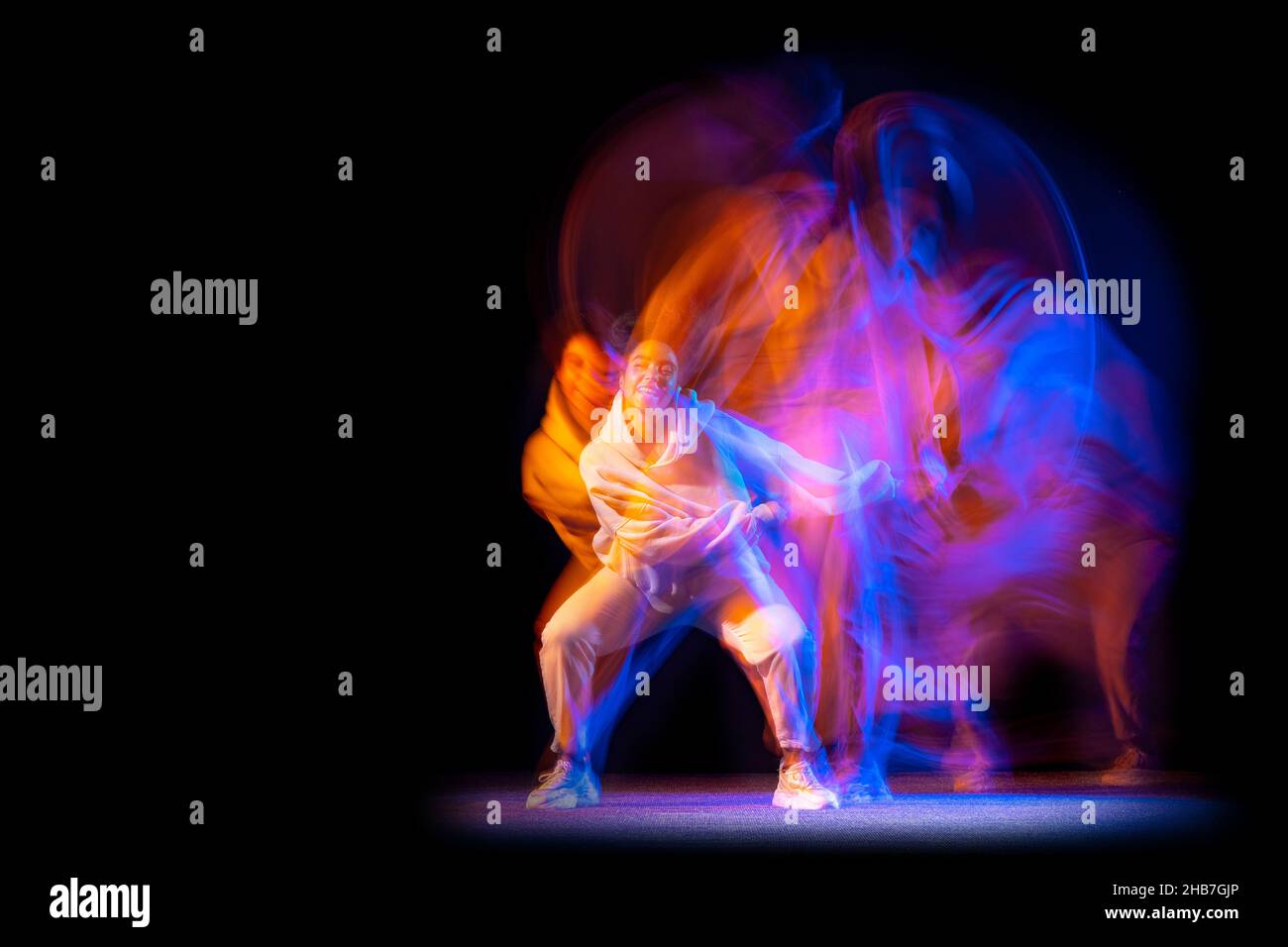 Stylish young girl in white costume dancing hip-hop dance isolated on ...