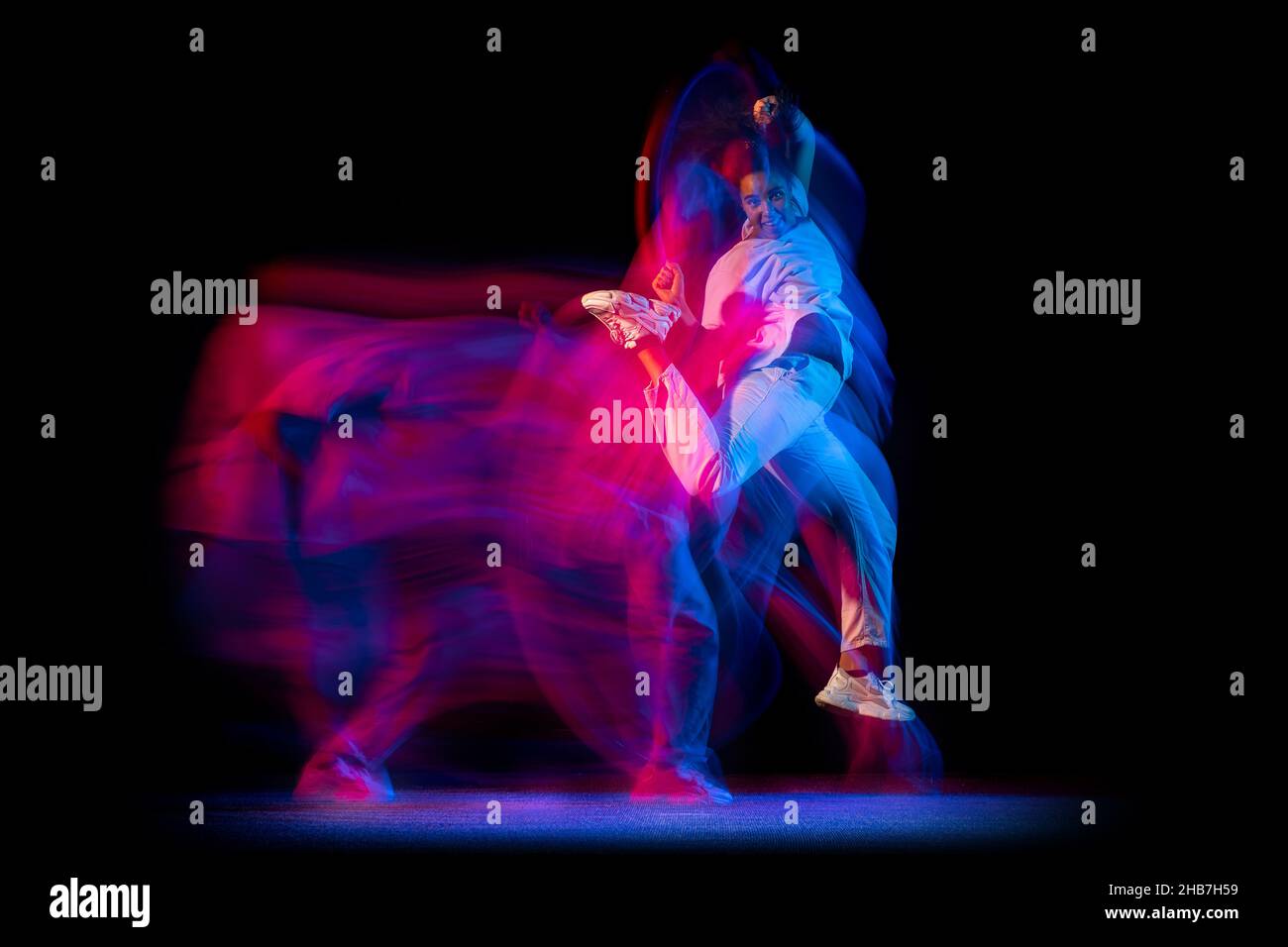 Stylish young girl in white costume dancing hip-hop dance isolated on ...