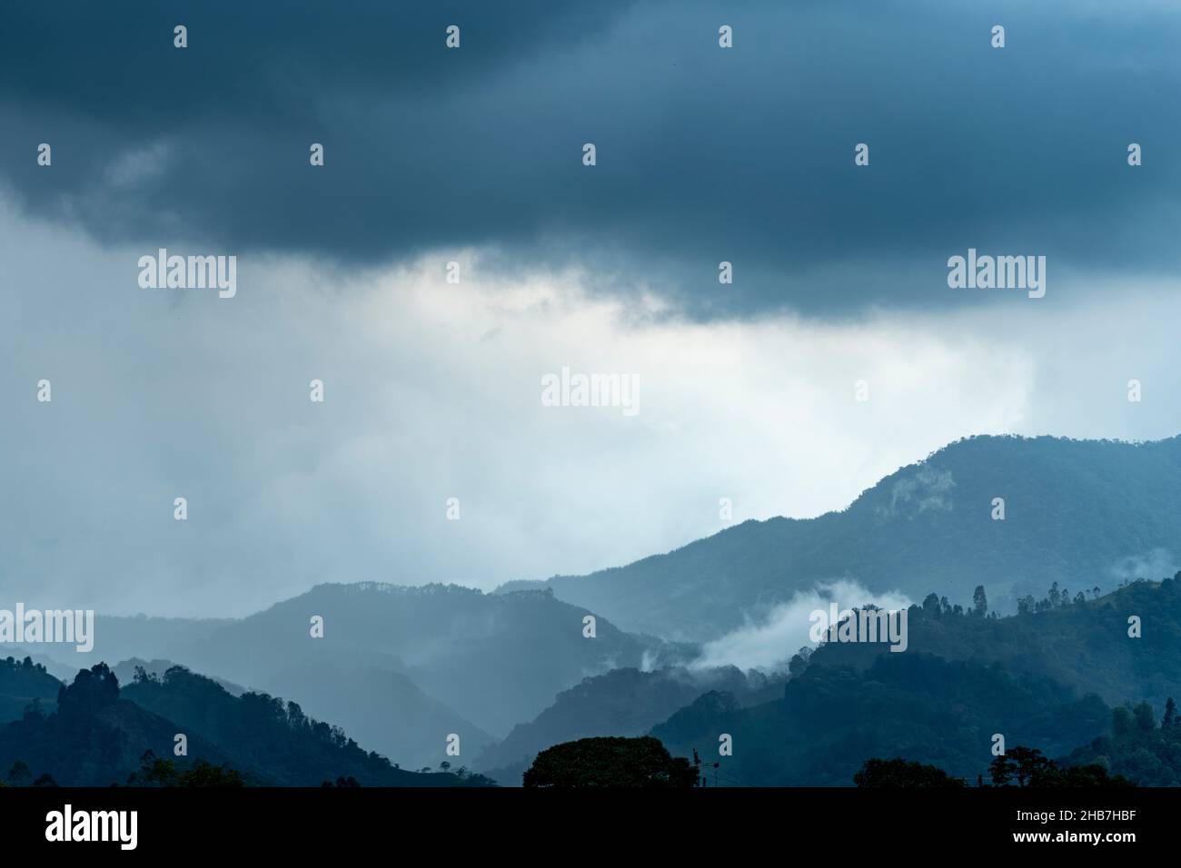 Rainy weather over the Andes mountains in the evening, Armenia region, Colombia, South America Stock Photo
