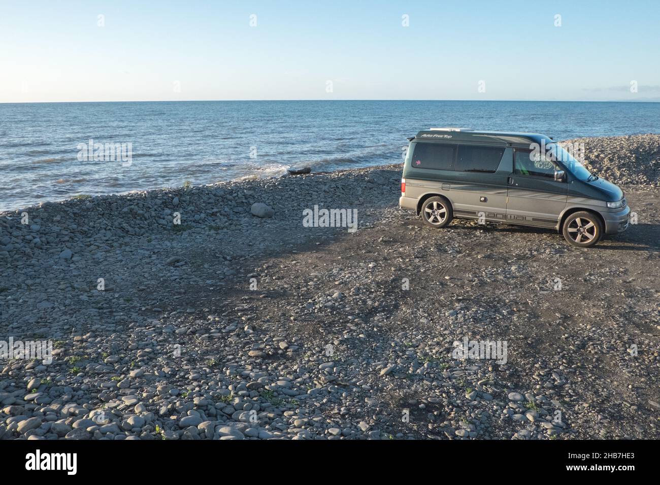 Mazda, Mazda Bongo,Mazda Bongo Friendee,campervan,van,van life,vanlife,staycation,at,coast,coastal,pebble,pebbled,beach,seascape,landcape,Llanon,Llanon Beach, car park,Ceredigion,county,West,Mid,Wales,Welsh, Great Britain,British,GB,UK,United Kingdom,Europe,European, Stock Photo