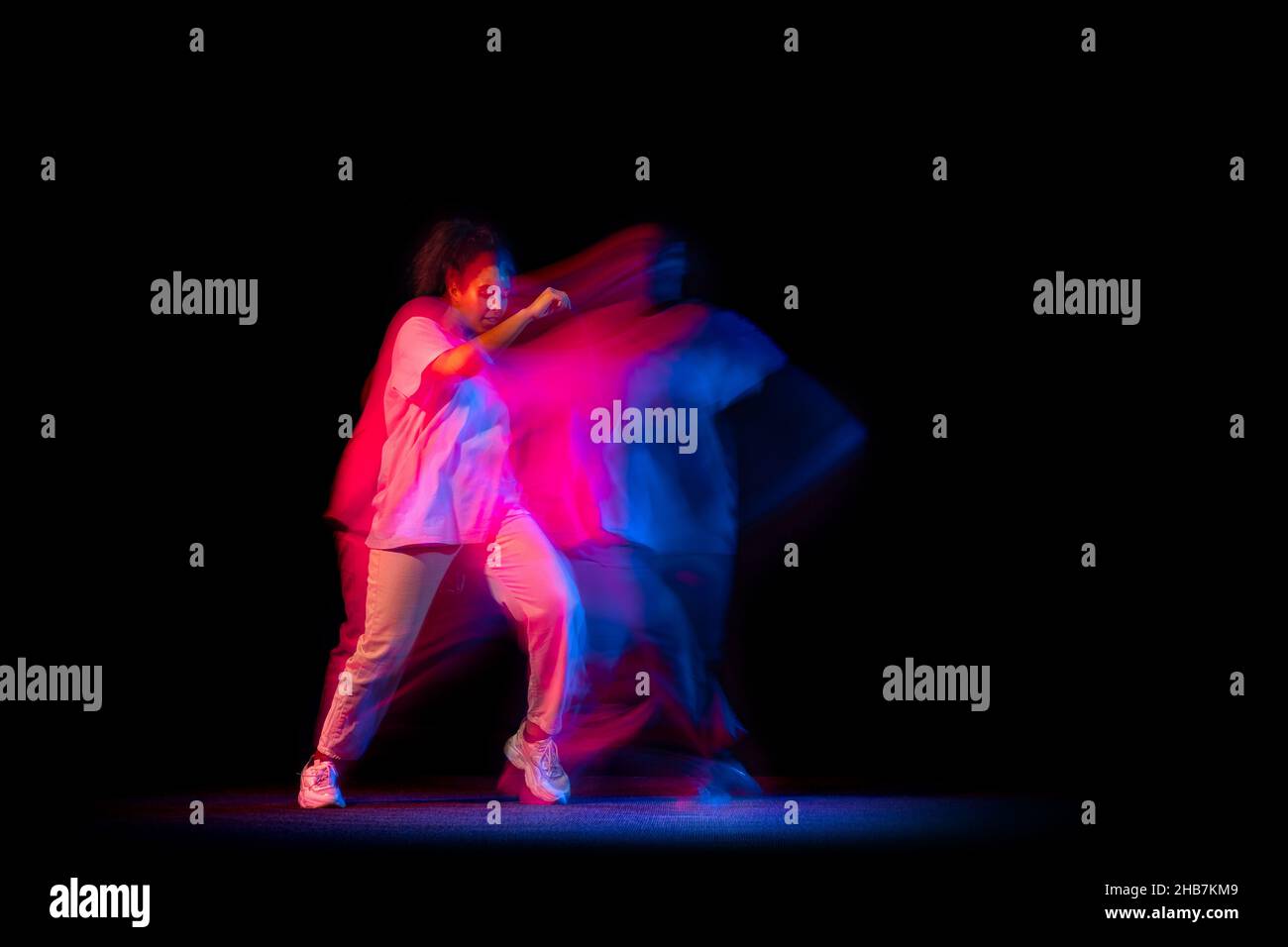 One young sportive girl in white costume dancing hip-hop dance isolated ...