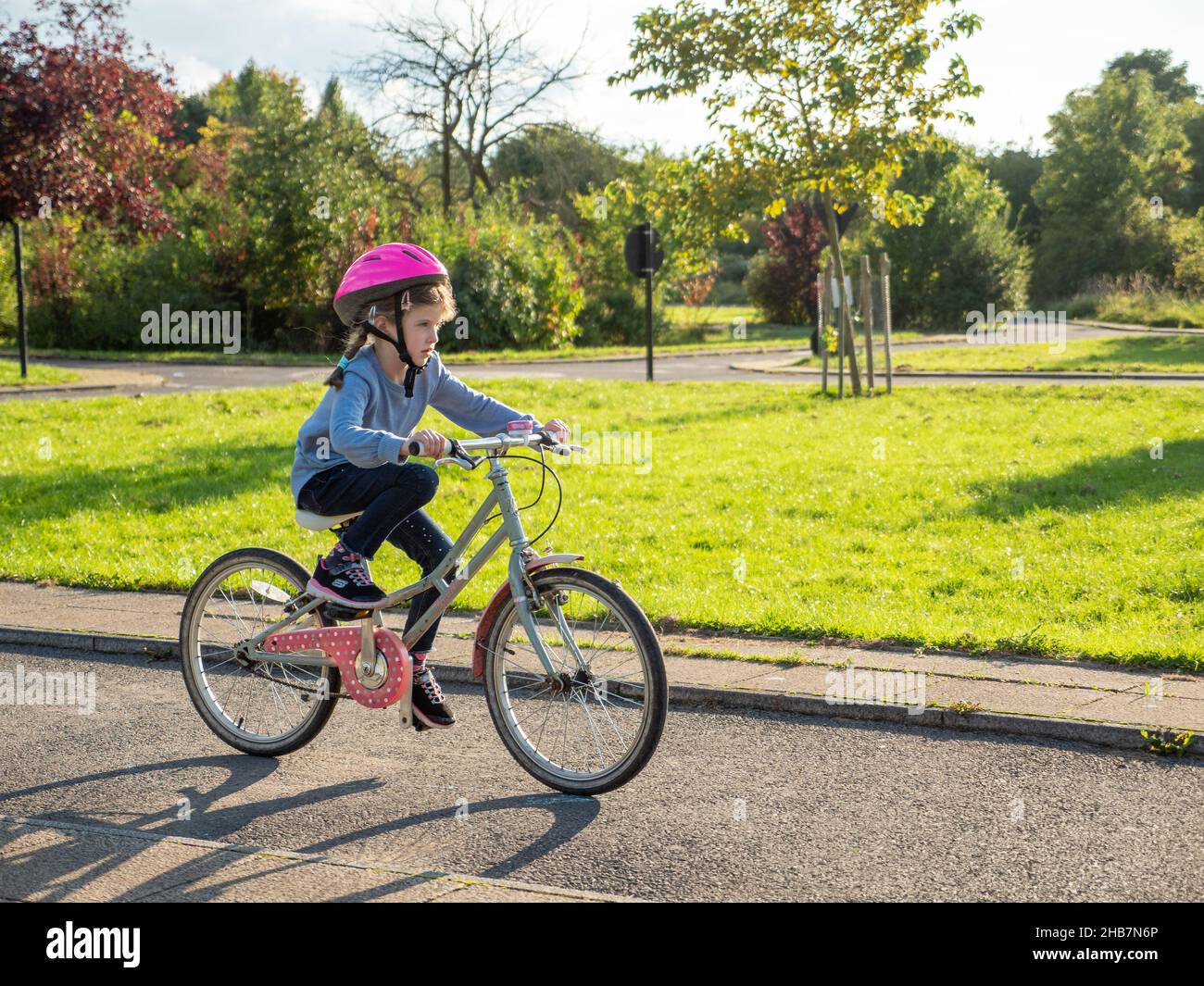 Child riding her bicycle on the The Model Traffic Area in Lordship Recreation Ground, Haringey, London, UK Stock Photo