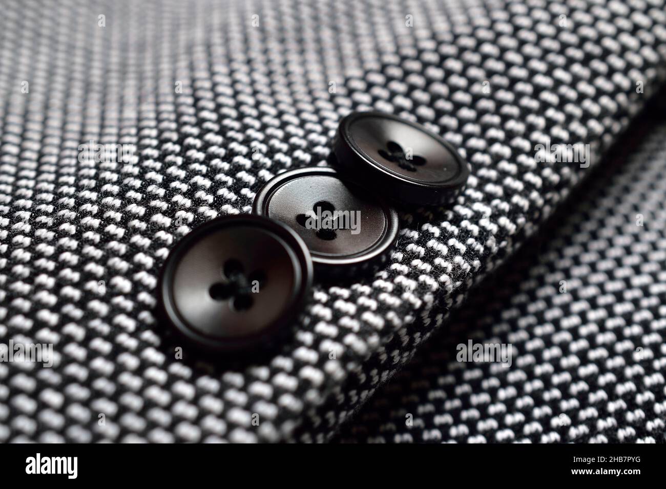 Black Button on Tweed Suit Stock Photo