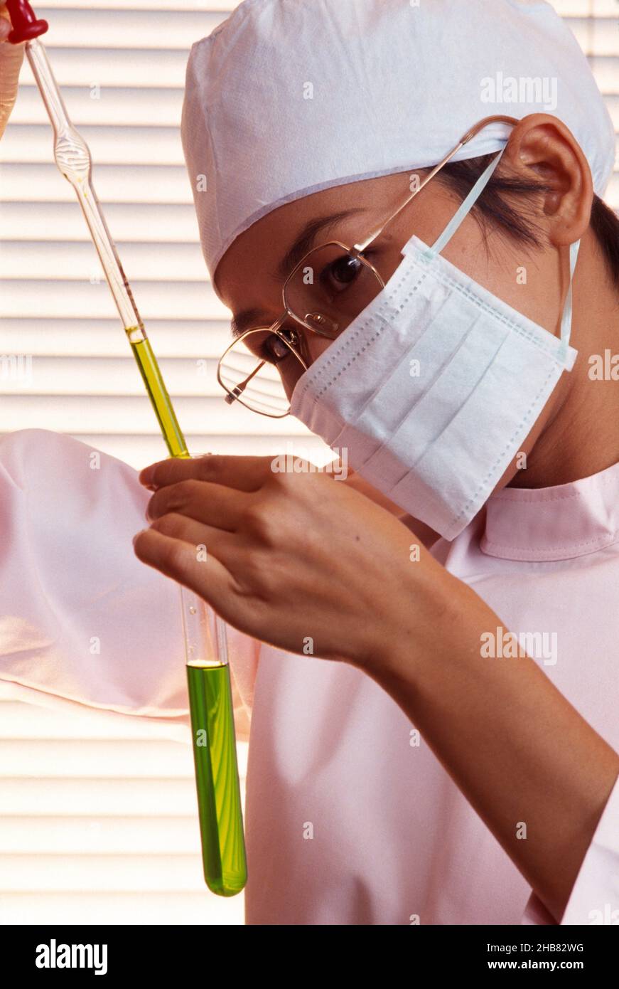 Japan. Close up of young woman working in biofuels laboratory. Stock Photo