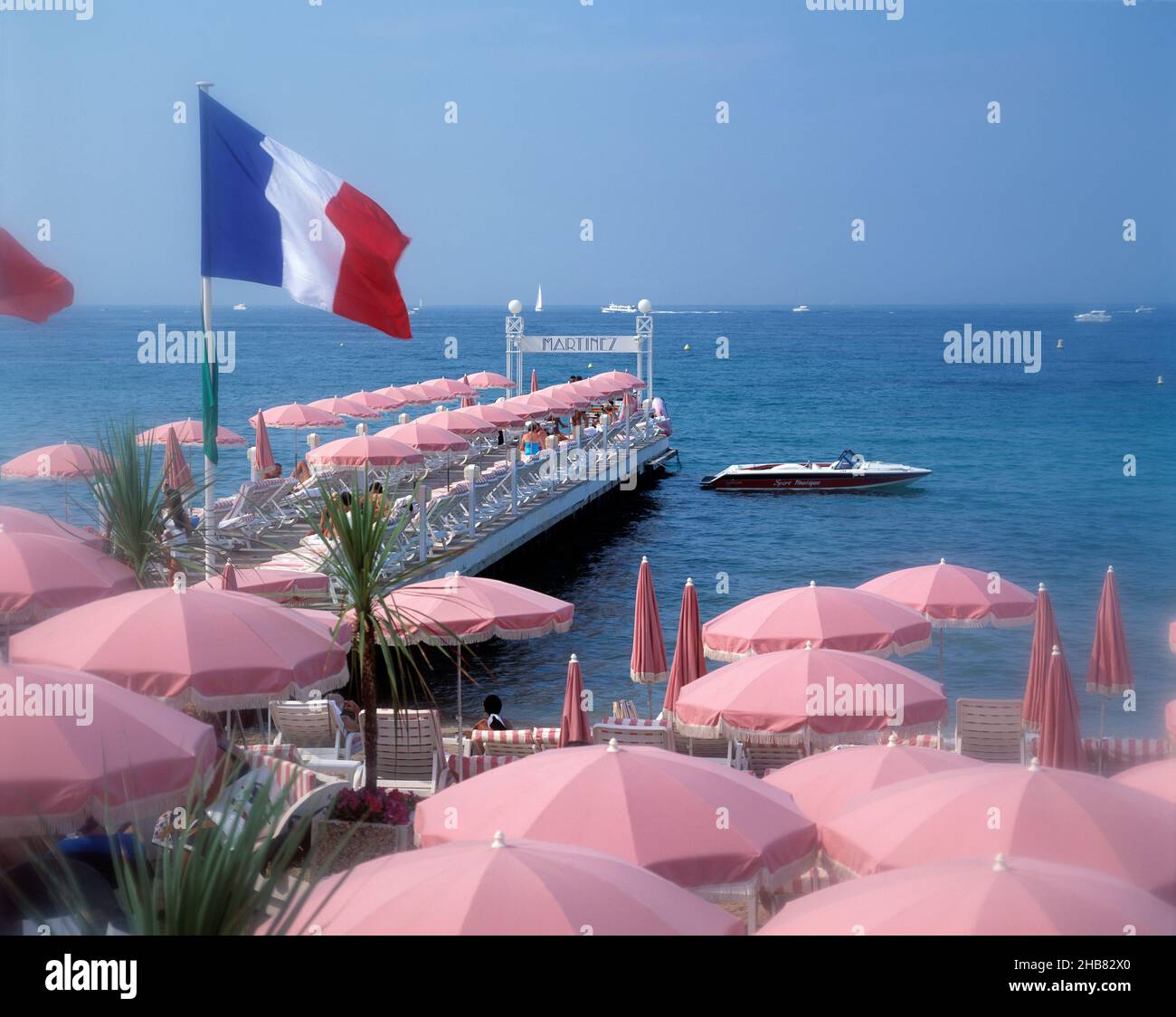 France. Provence Cote d'Azur. Cannes. Hotel Martinez pier and sun umbrellas. Stock Photo