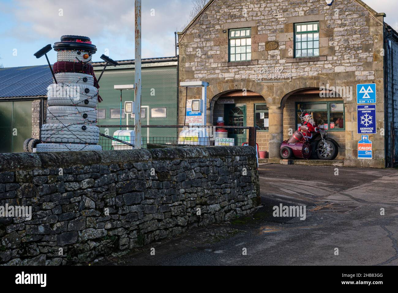 A Christmas snowman made out of tyres at the village petrol station, Hartington, Peak District National Park, Derbyshire Stock Photo