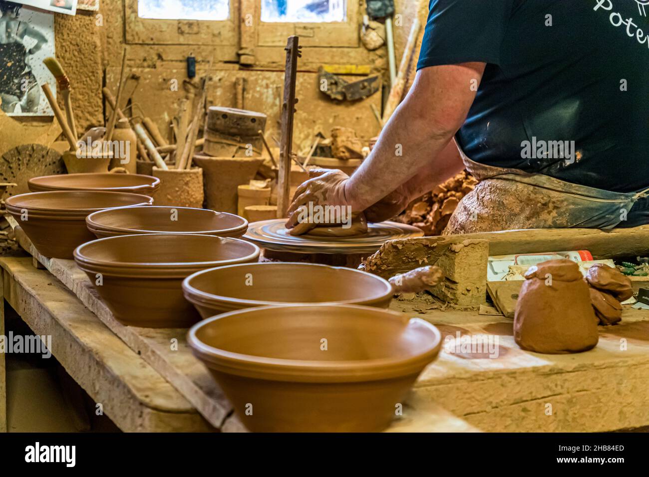 Poterie NOT in Mas-Saintes-Puelles, France. Cassole is the earthen ceramic mold in which the cassoulet is prepared. Cassoulet is a communal meal. Popular is the size for 8 people. Forming a cassole takes about 10 minutes. Handles are put on and the company stamp is placed. Stock Photo