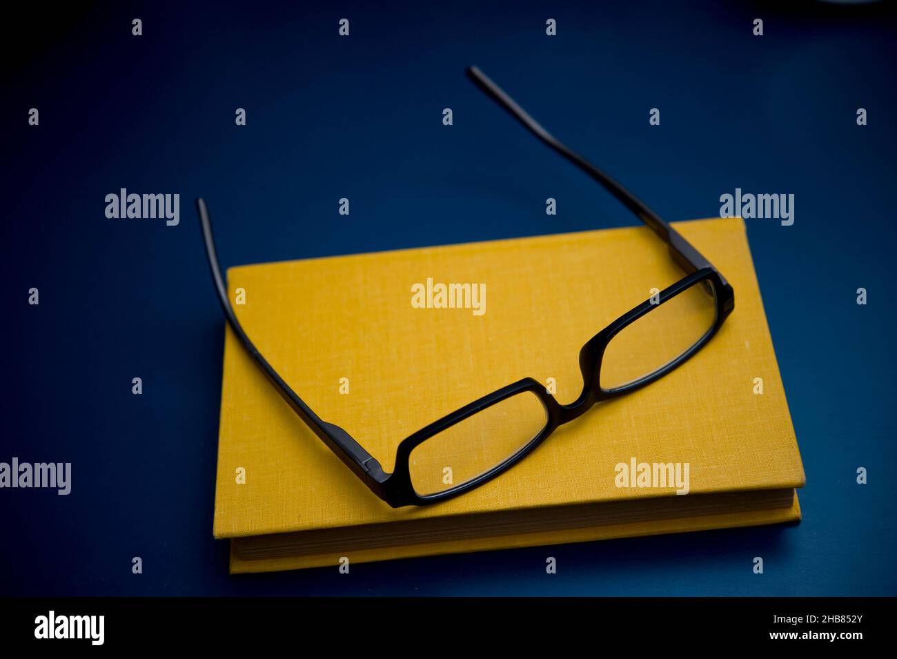 yellow book and reading glasses Stock Photo