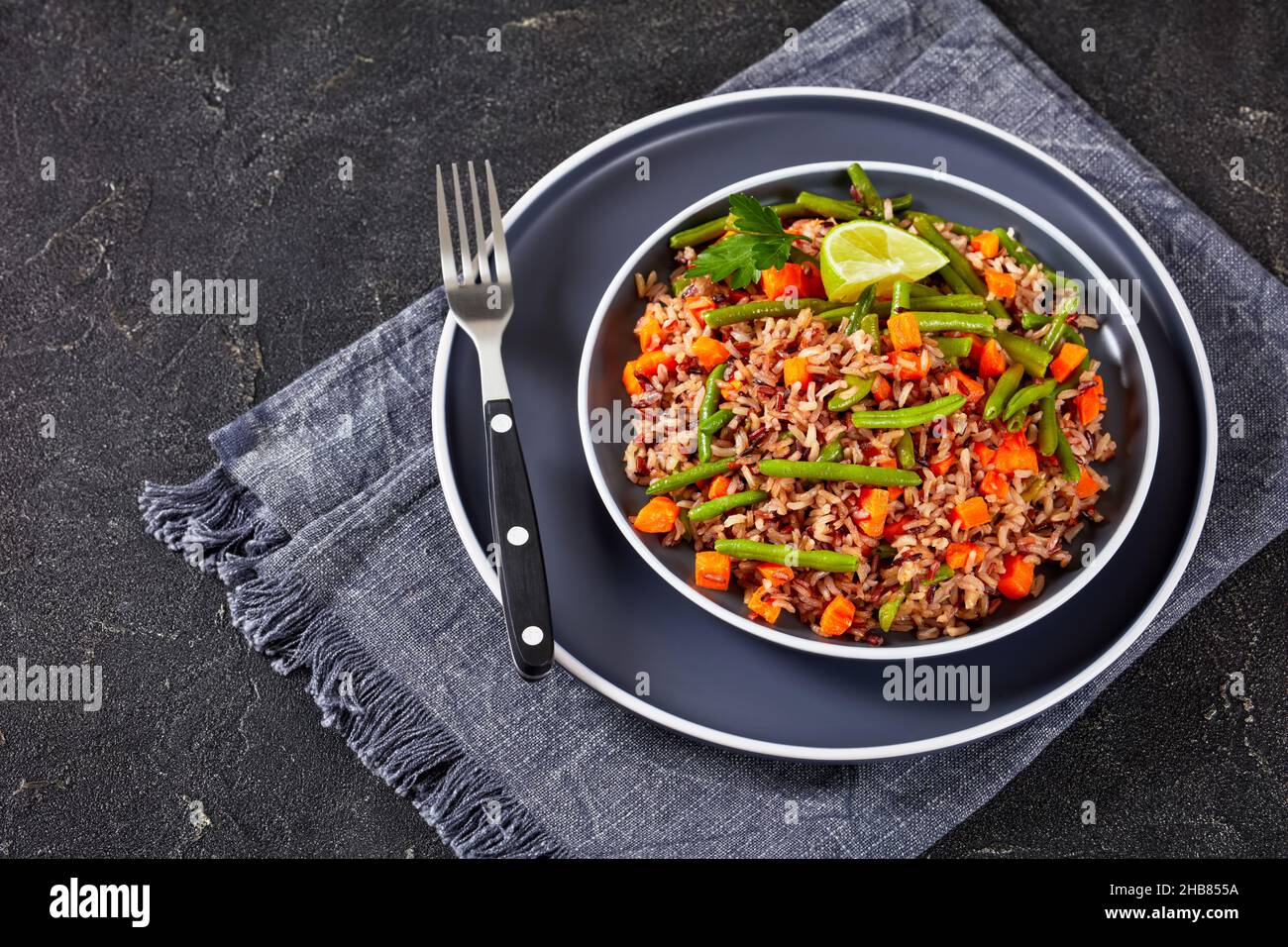 healthy fried brown and wild rice with green beans and carrot on a