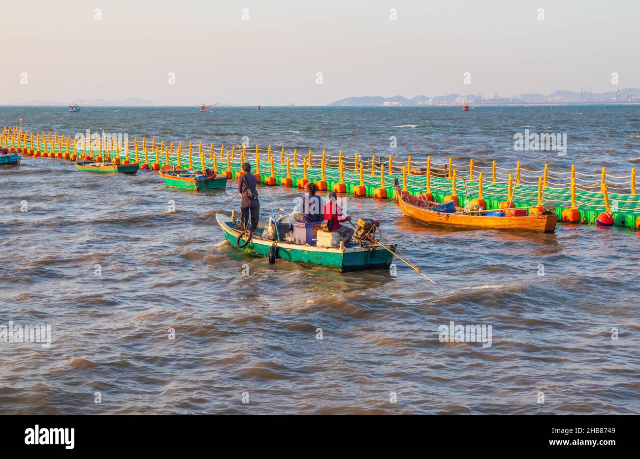 The fishermen take their boats out to sea in the early evening Stock Photo