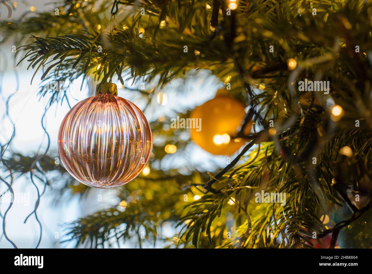 décorations et boules de noël sur un sapin pendant les fêtes de fin d'année. Christmas decorations and baubles on a tree during the festive season. Stock Photo