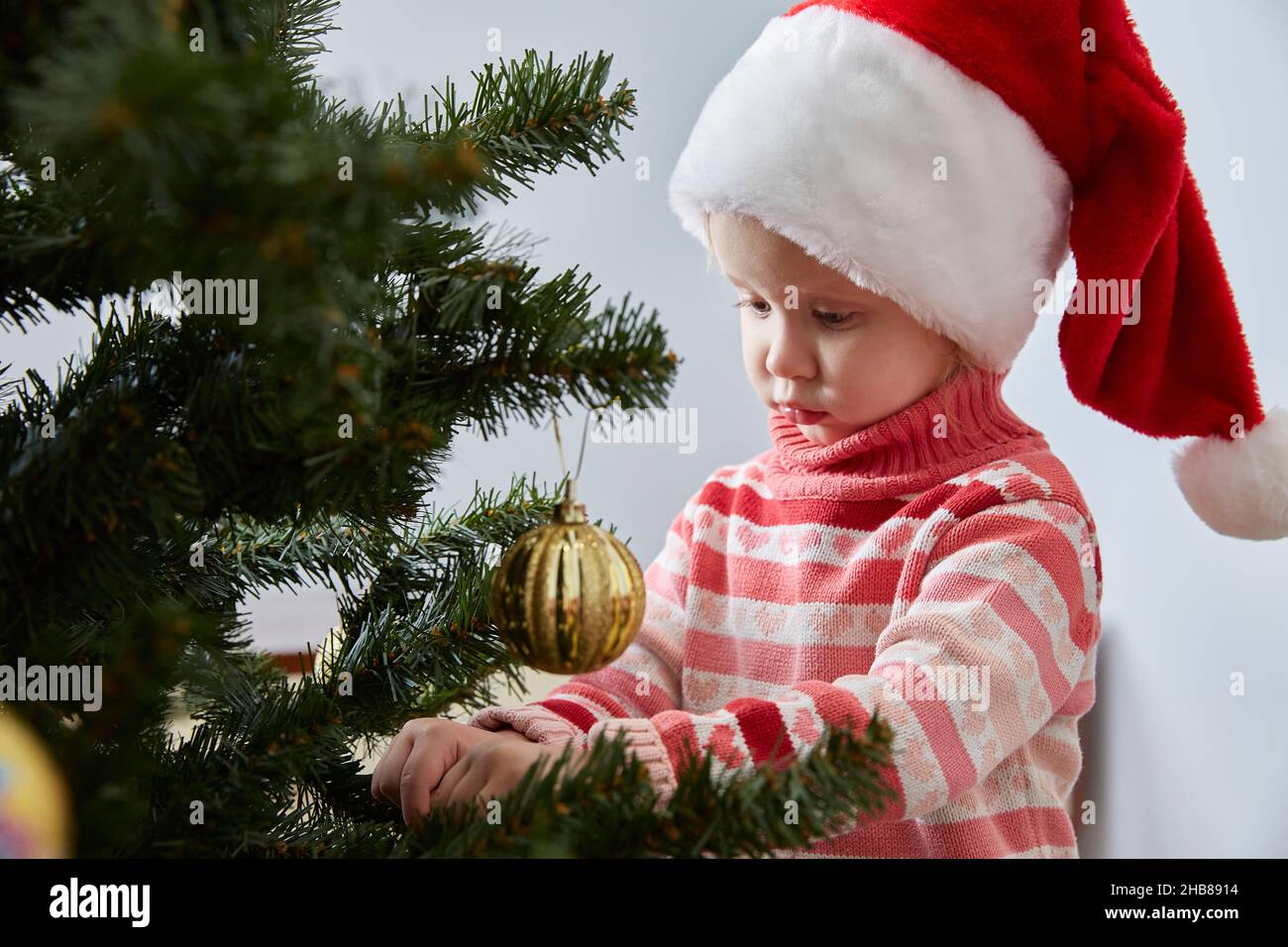 Santa hat hangs a Christmas ball 