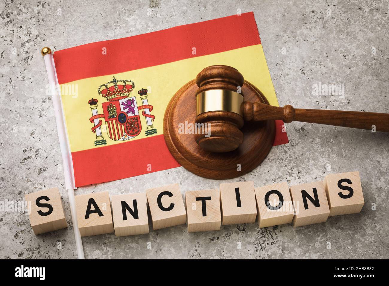 Spanish flag, judge gavel and wooden cubes with text, concept on the theme of sanctions from Spain Stock Photo