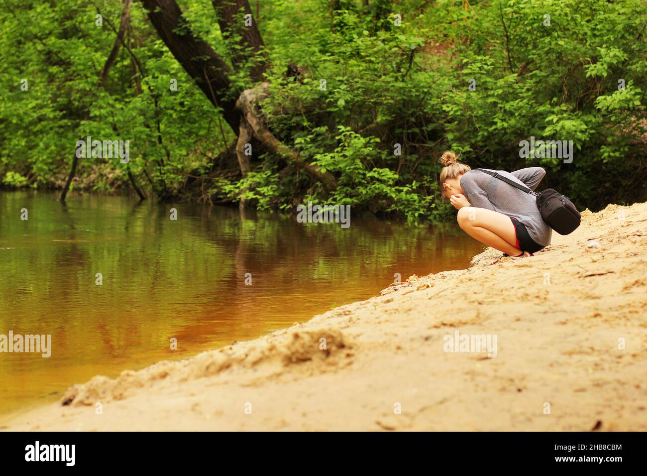 Beautiful girl on the river bank Stock Photo - Alamy