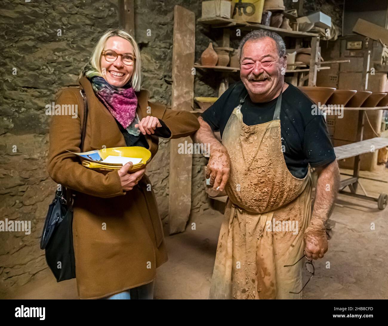 Food Journalist Angela Berg with the owner of Poterie NOT in Mas-Saintes-Puelles, France. Cassole is the earthen ceramic mold in which the cassoulet is prepared Stock Photo