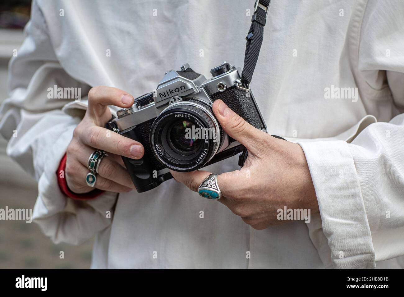 close up of a man holding a retro camera, front view Stock Photo