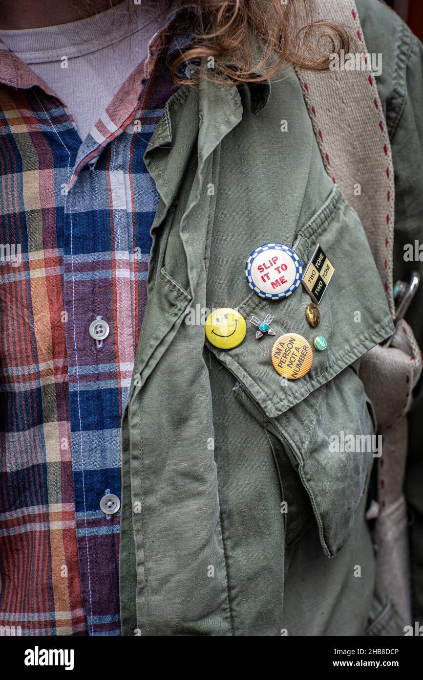 Variety of badges on a khaki jacket. Stock Photo