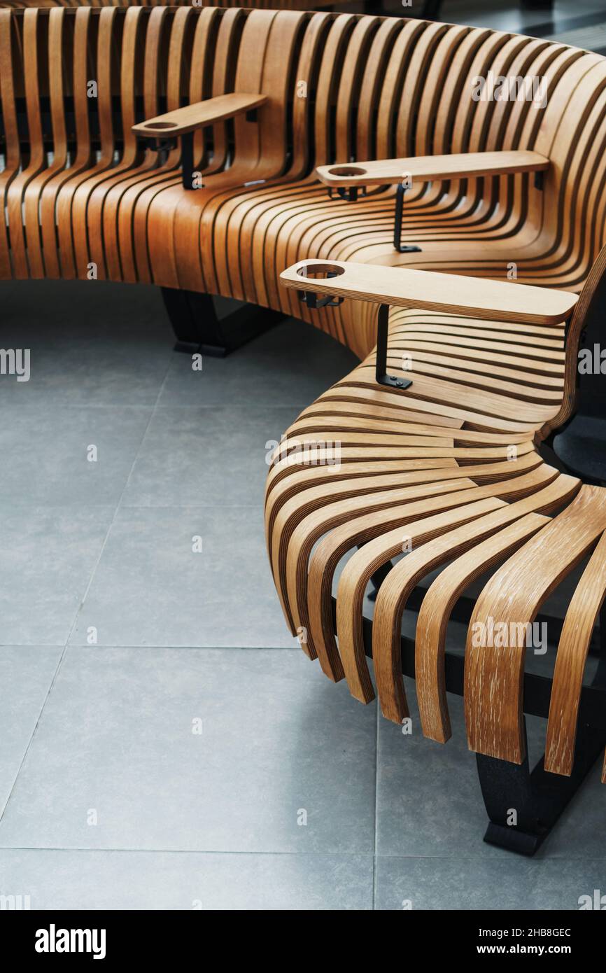 Modern curved wooden bench at the airport. Modern interior Stock Photo ...