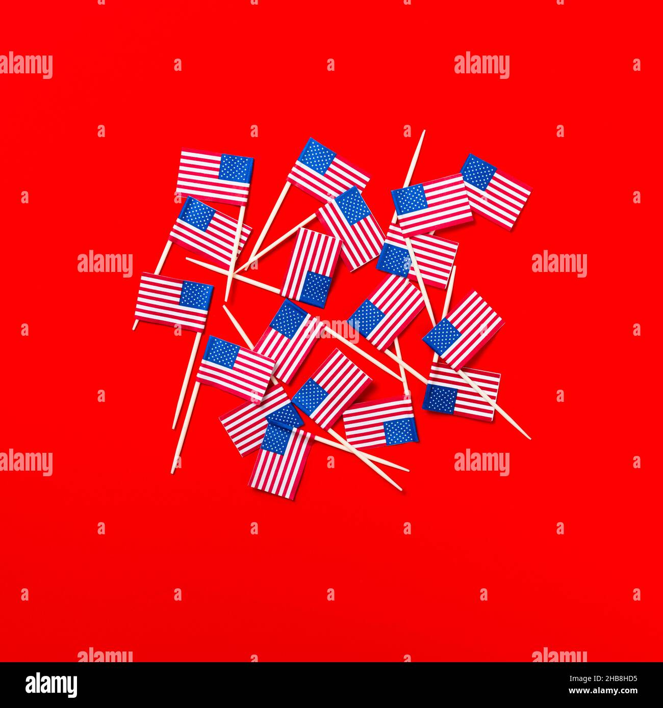 Small American flag toothpicks on red background Stock Photo - Alamy