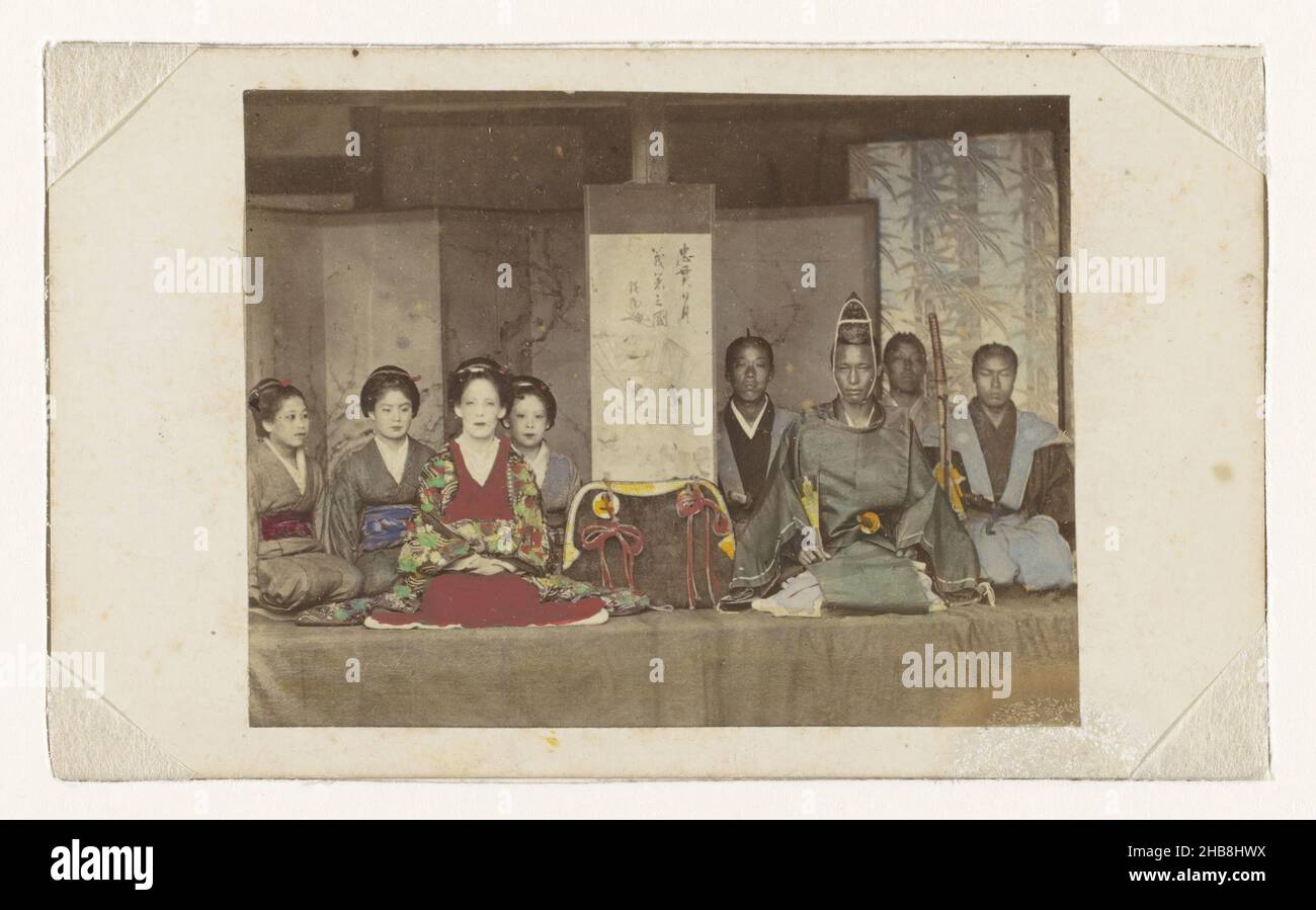 Group portrait of eight unknown Japanese women and men in kimono costumes, anonymous, Japan, 1855 - 1900, paper, cardboard, albumen print, height 55 mm × width 71 mmheight 64 mm × width 105 mm Stock Photo