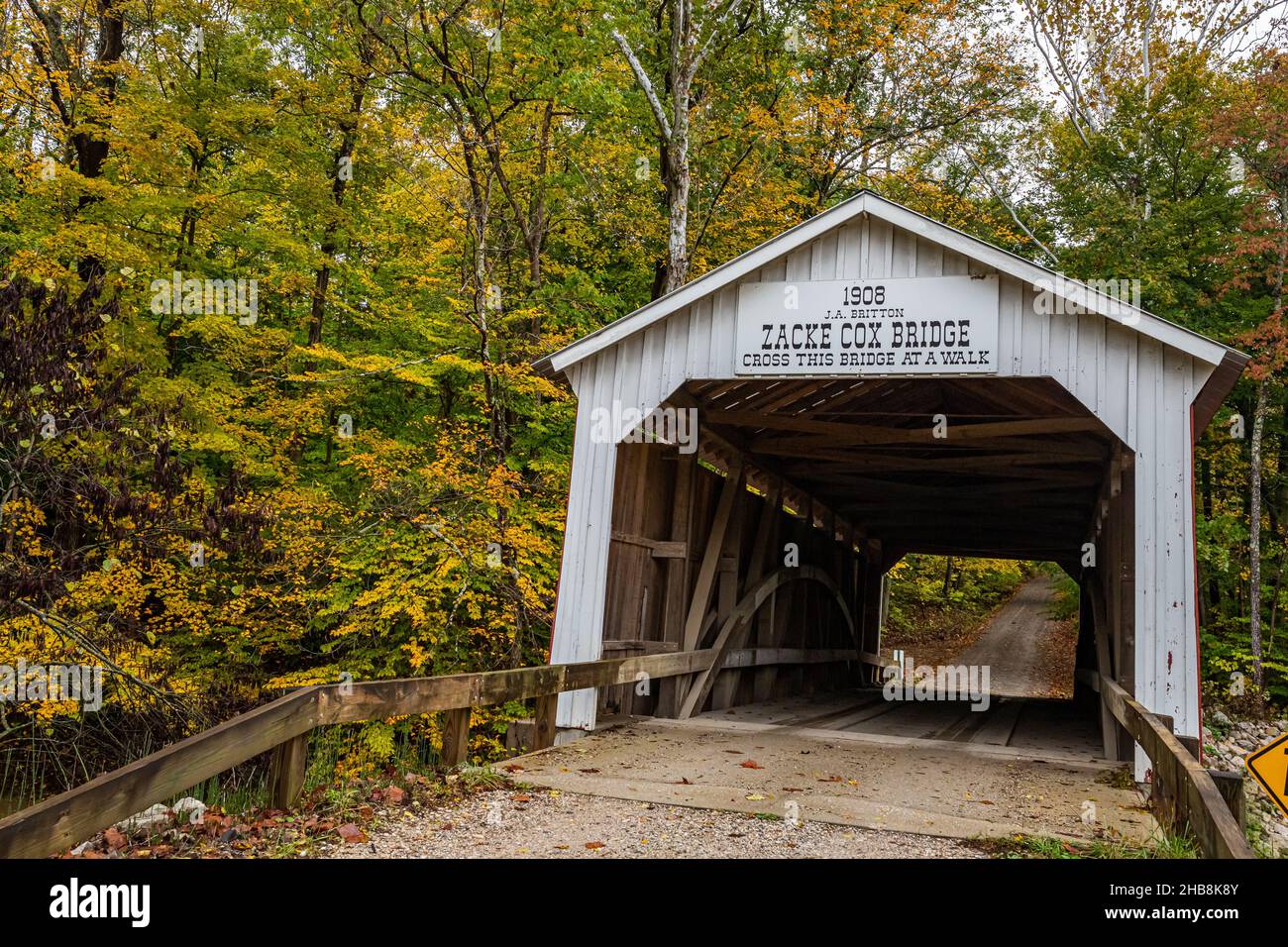 The Zacke Cox Covered Bridge crosses Rock Run Creek during Autumn leaf color change near Rockville in Parke County, Indiana. Stock Photo