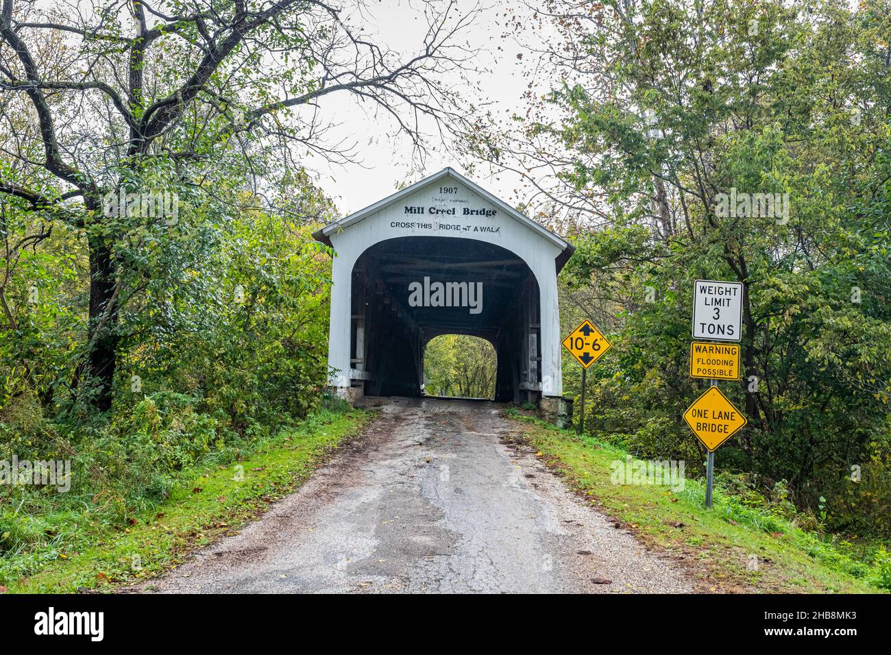 The Mill Creek Covered Bridge crosses Mill Creek during Autumn leaf