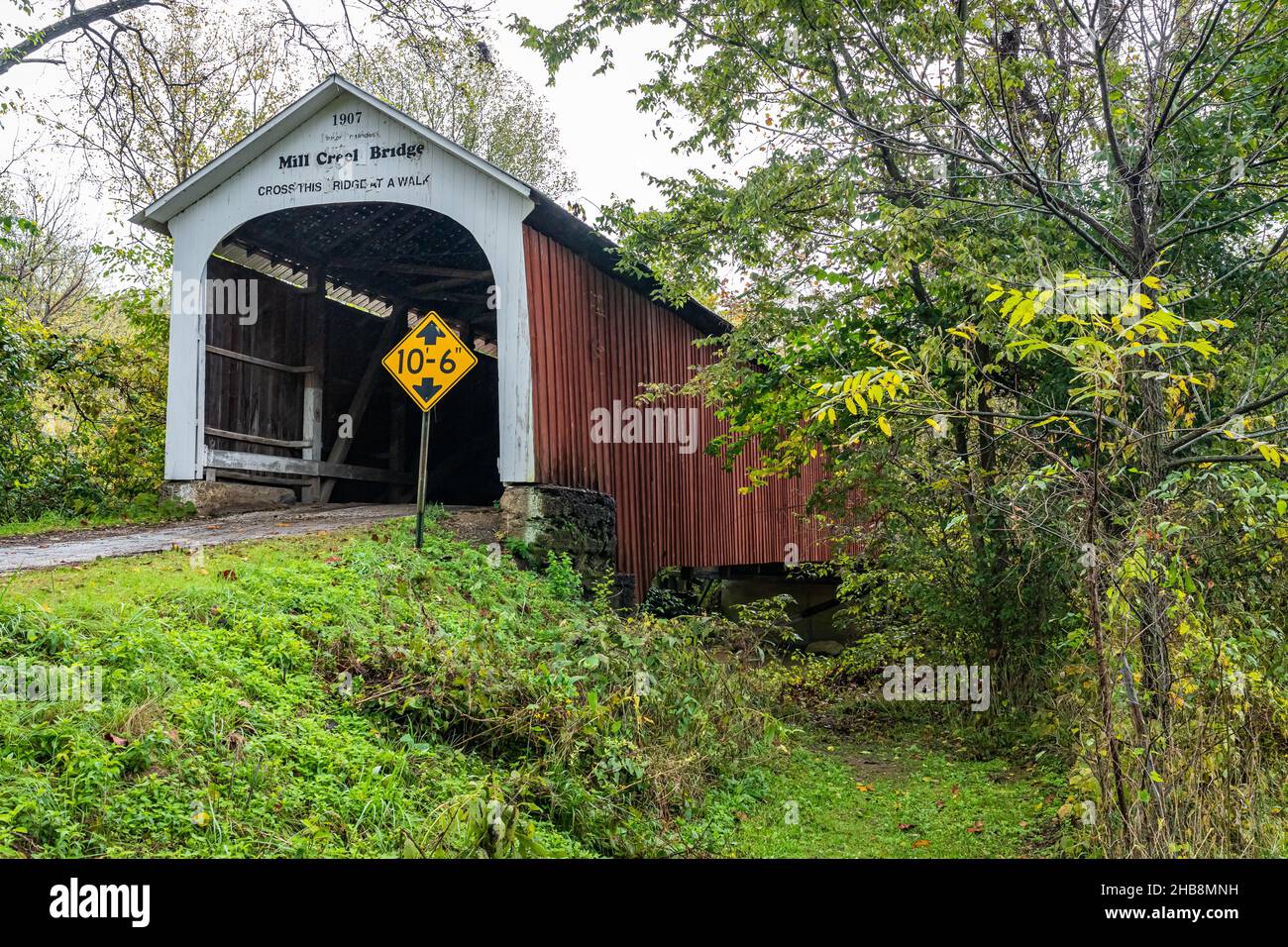 The Mill Creek Covered Bridge crosses Mill Creek during Autumn leaf