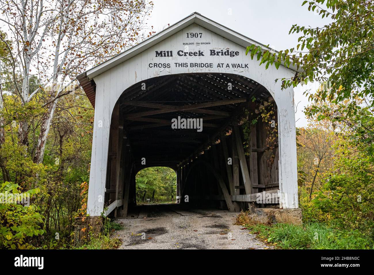The Mill Creek Covered Bridge crosses Mill Creek during Autumn leaf