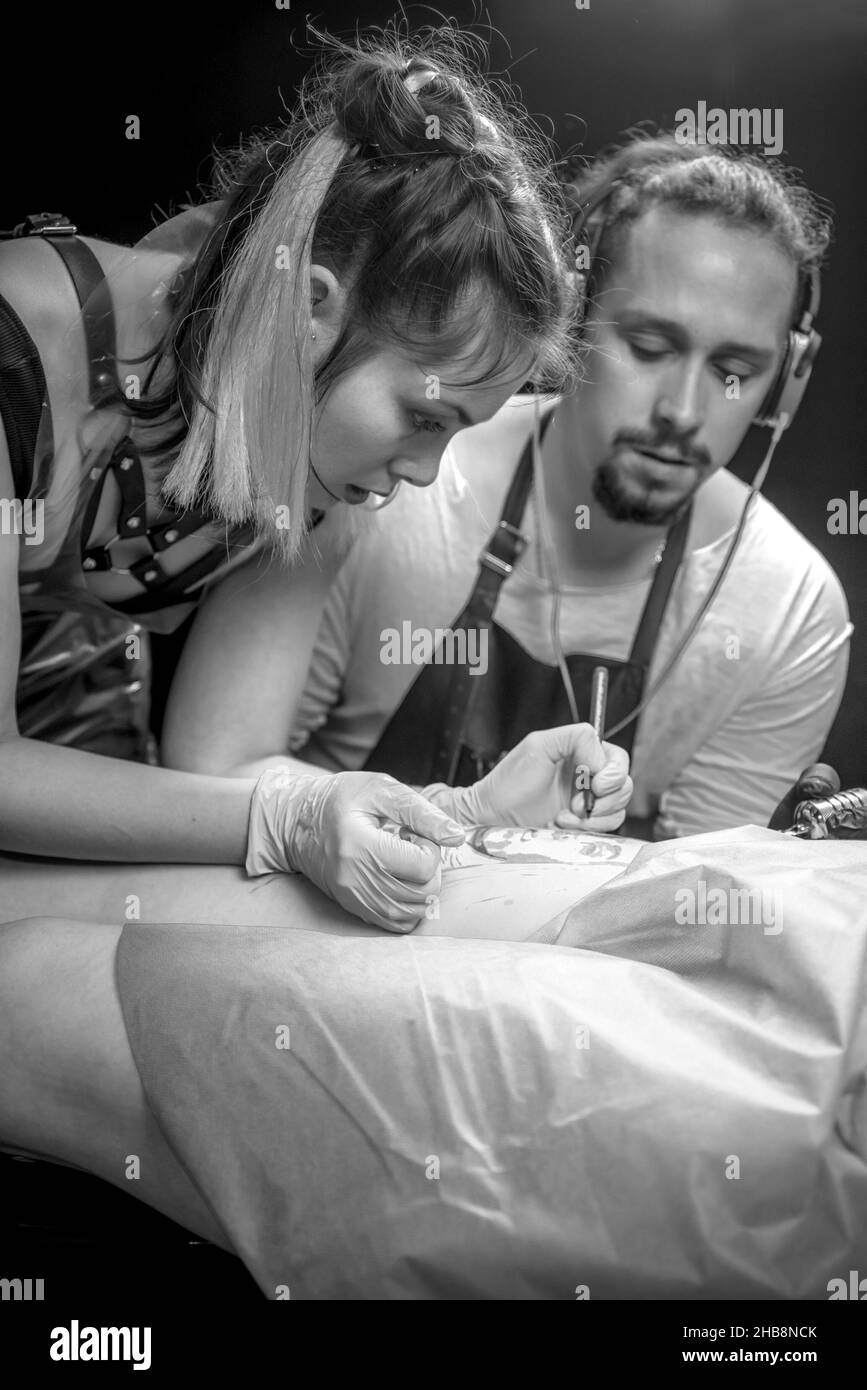 Master of the art of tattooing makes tattoo art Stock Photo