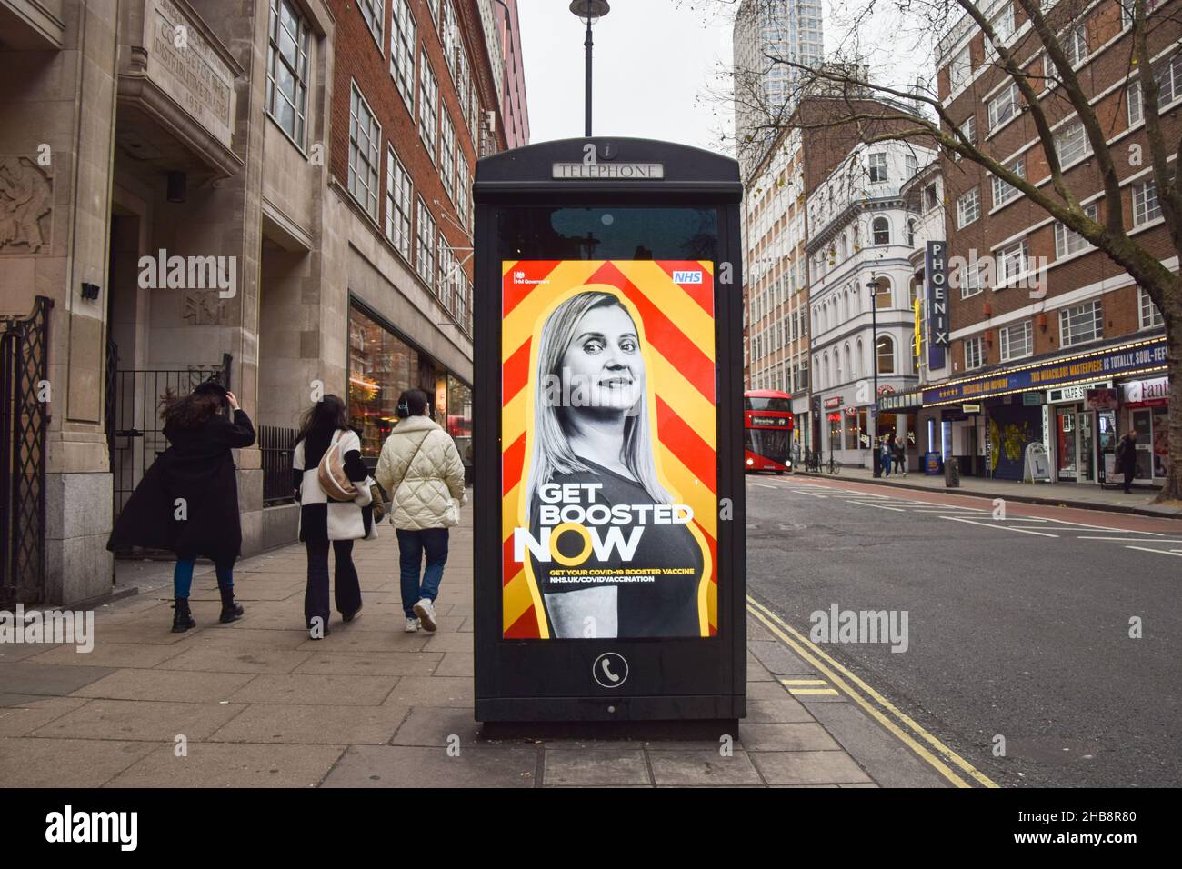 London, UK. 17th Dec, 2021. People walk past a poster urging everyone to get a booster vaccine on Charing Cross Road as the Omicron variant of COVID-19 spreads in the UK. (Credit Image: © Vuk Valcic/SOPA Images via ZUMA Press Wire) Credit: ZUMA Press, Inc./Alamy Live News Stock Photo