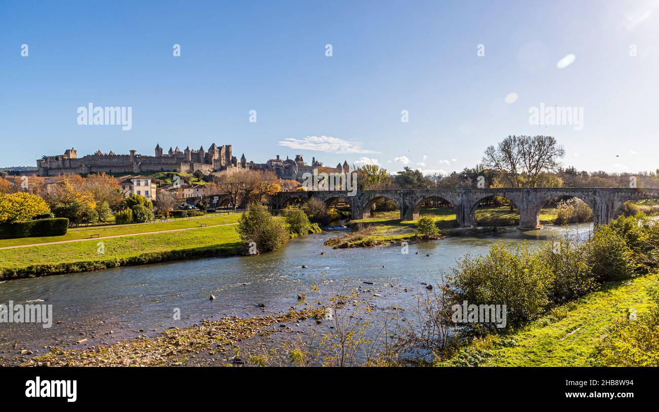 The old town fortress of Carcassonne is located behind the 14th century Pont Vieux, which crosses the river Aude. Carcassonne, France Stock Photo