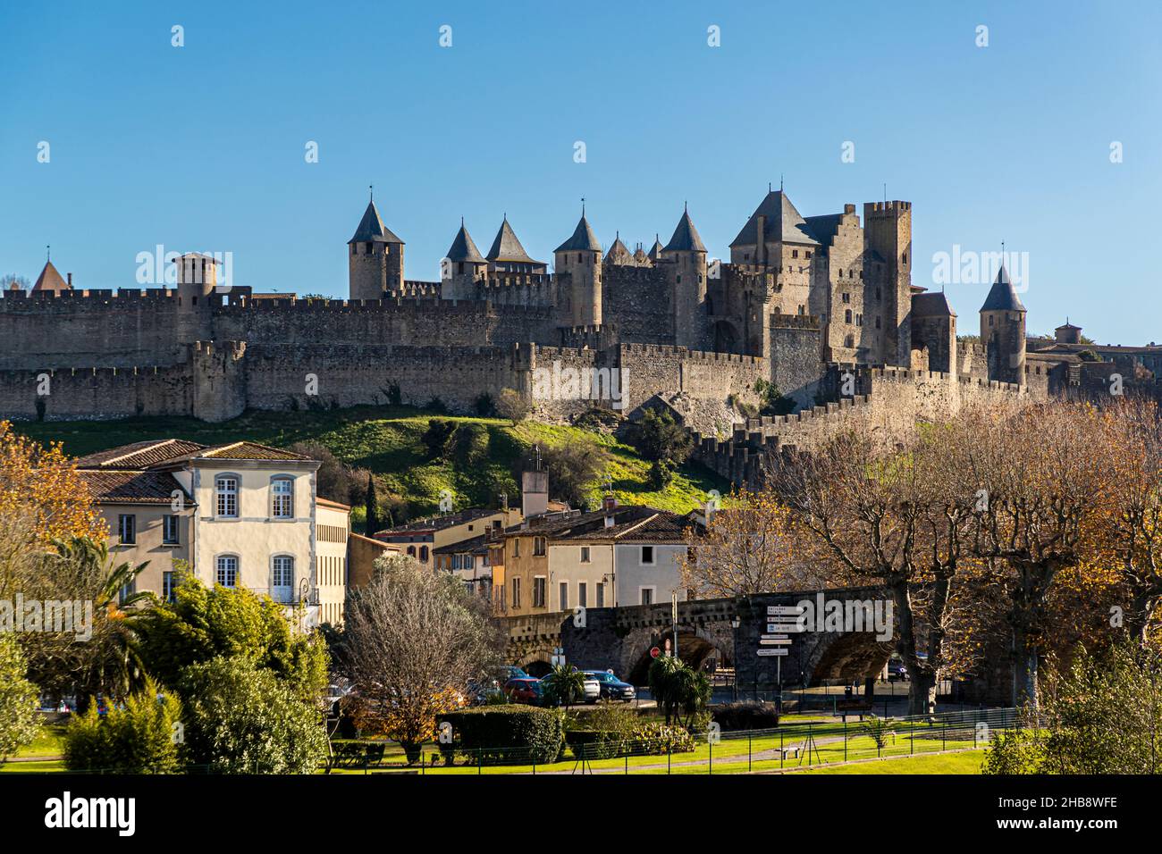 The old town fortress of Carcassonne is located behind the 14th century Pont Vieux, which crosses the river Aude. Carcassonne, France Stock Photo