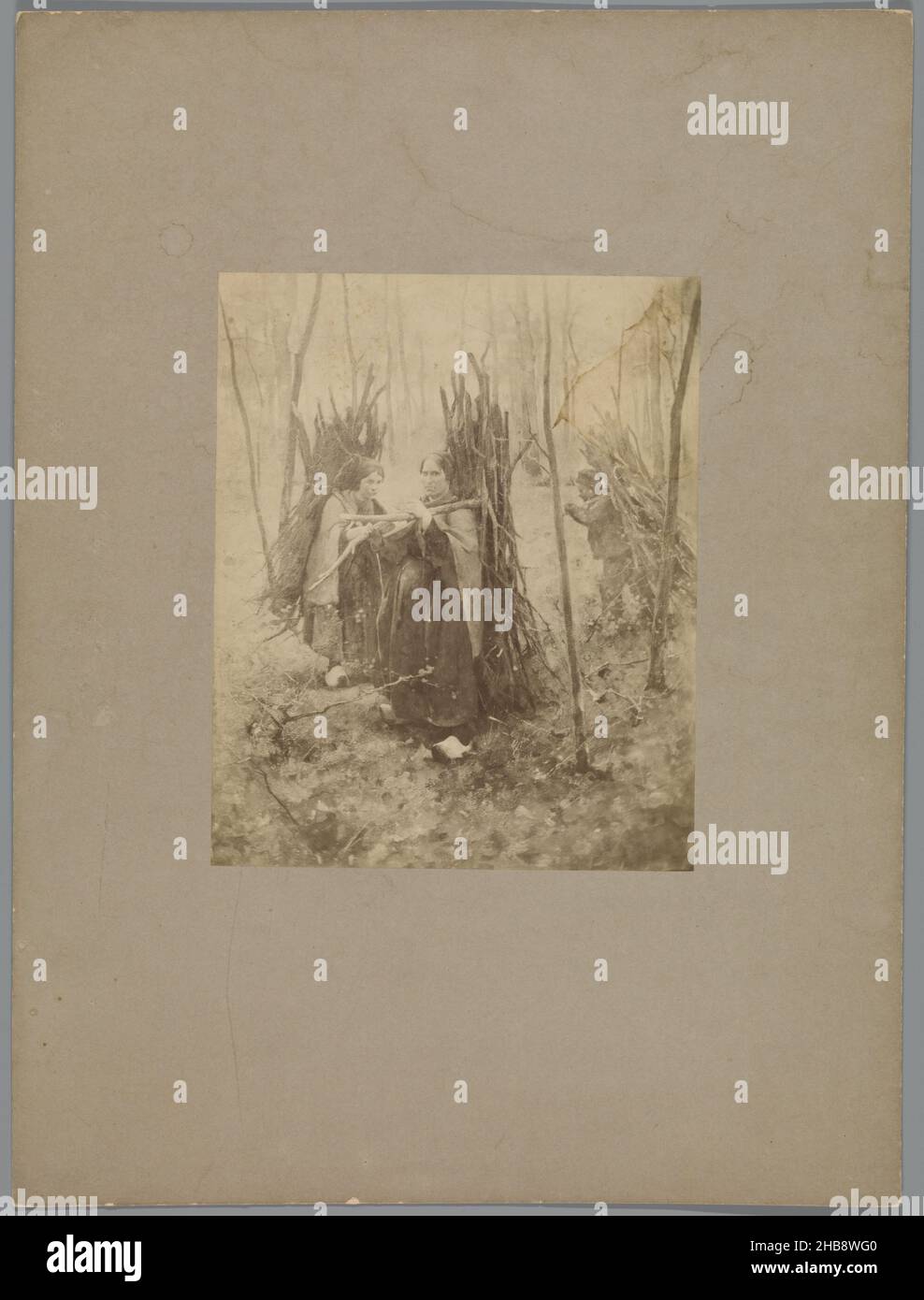 Reproduction after a painting by Willem Witsen of two women and a child with branches on their backs, anonymous, Willem Witsen, Netherlands, c. 1860 - c. 1915, paper, cardboard, height 212 mm × width 172 mmheight 427 mm × width 320 mm Stock Photo