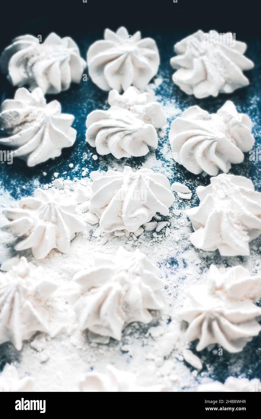 Meringue cookies on a blue background. Meringue background