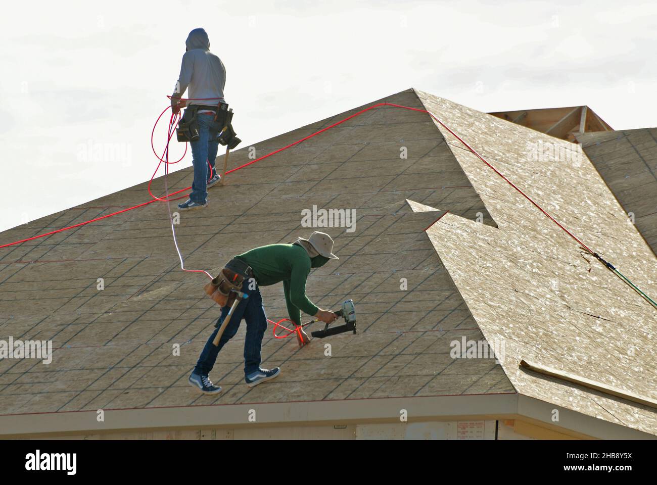 Workers roofing a new home. Stock Photo