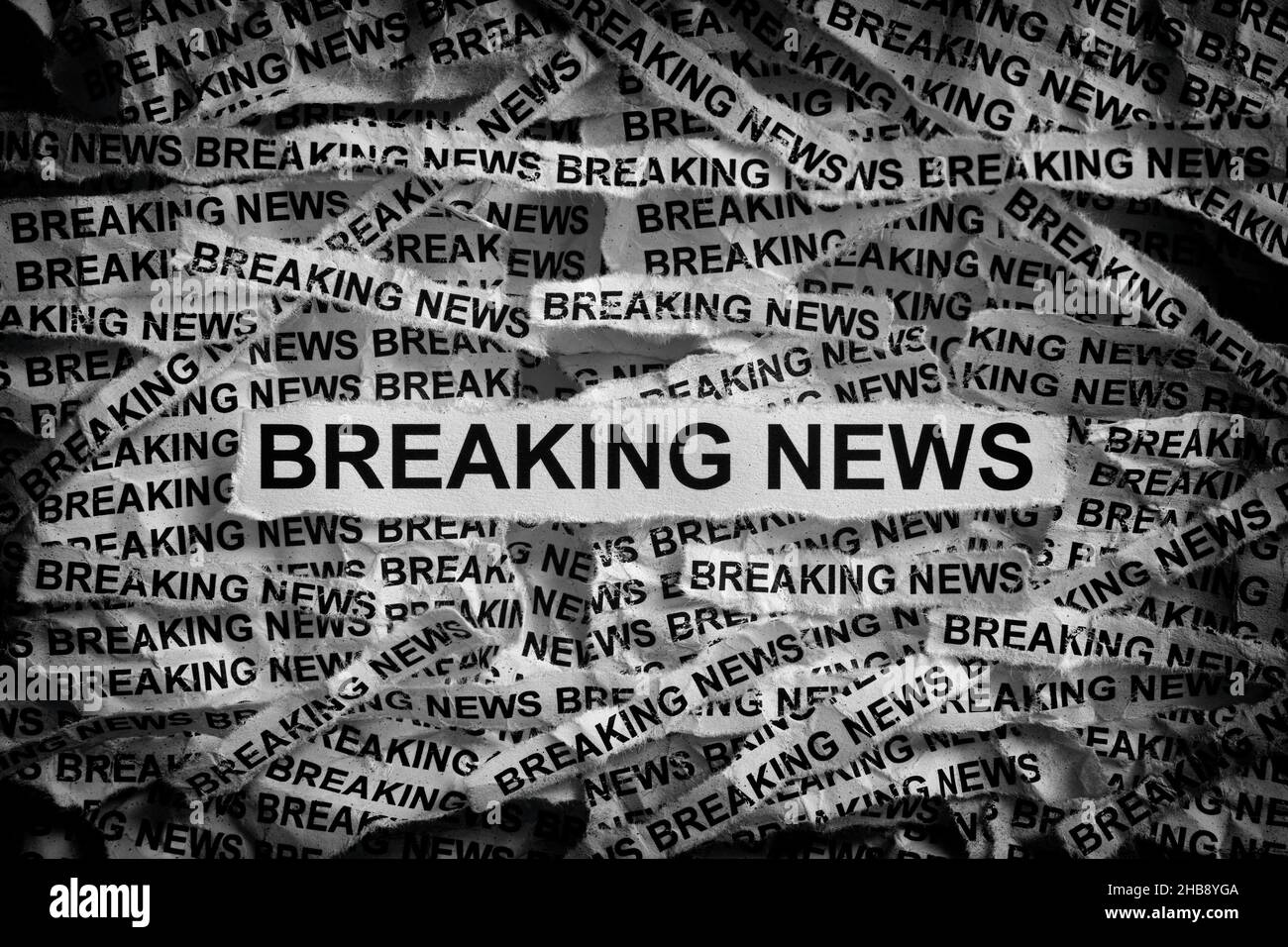 Strips of newspaper with the words Breaking News typed on them. Black and white. Close up. Stock Photo