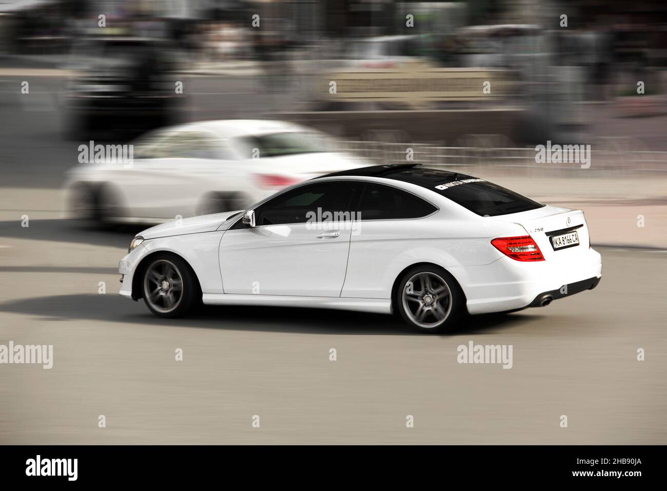 Kiev, Ukraine - May 22, 2021: White Mercedes-Benz C250 Coupe in motion Stock Photo
