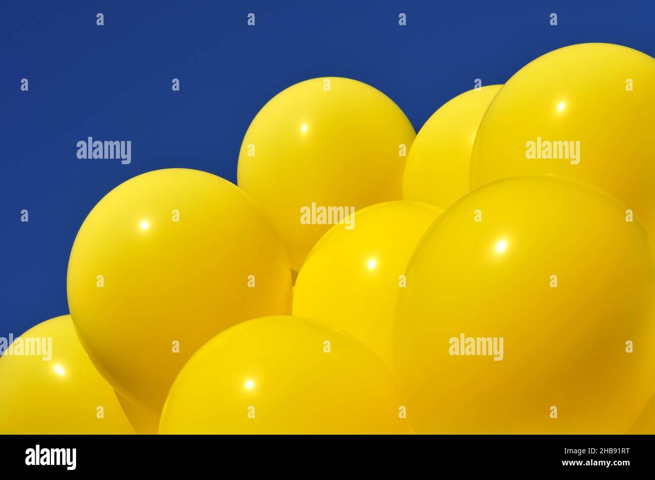 yellow balloons in the city festival against deep blue sky Stock Photo
