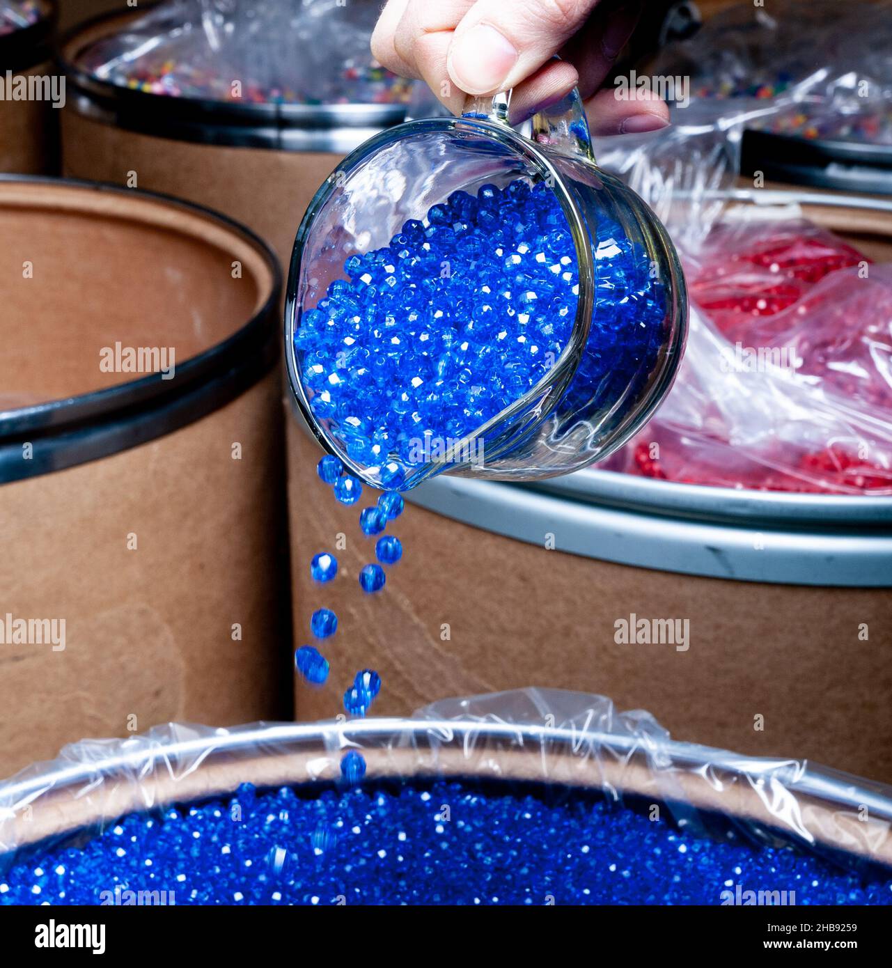 Pouring of Colorful plastic beads. Microplastics. Industrial plastic