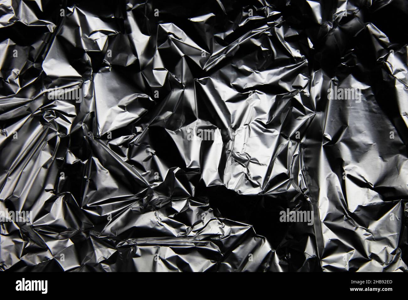 Foil background. Crumpled foil. Abstract background. Wallpaper. Gray Stock Photo Alamy