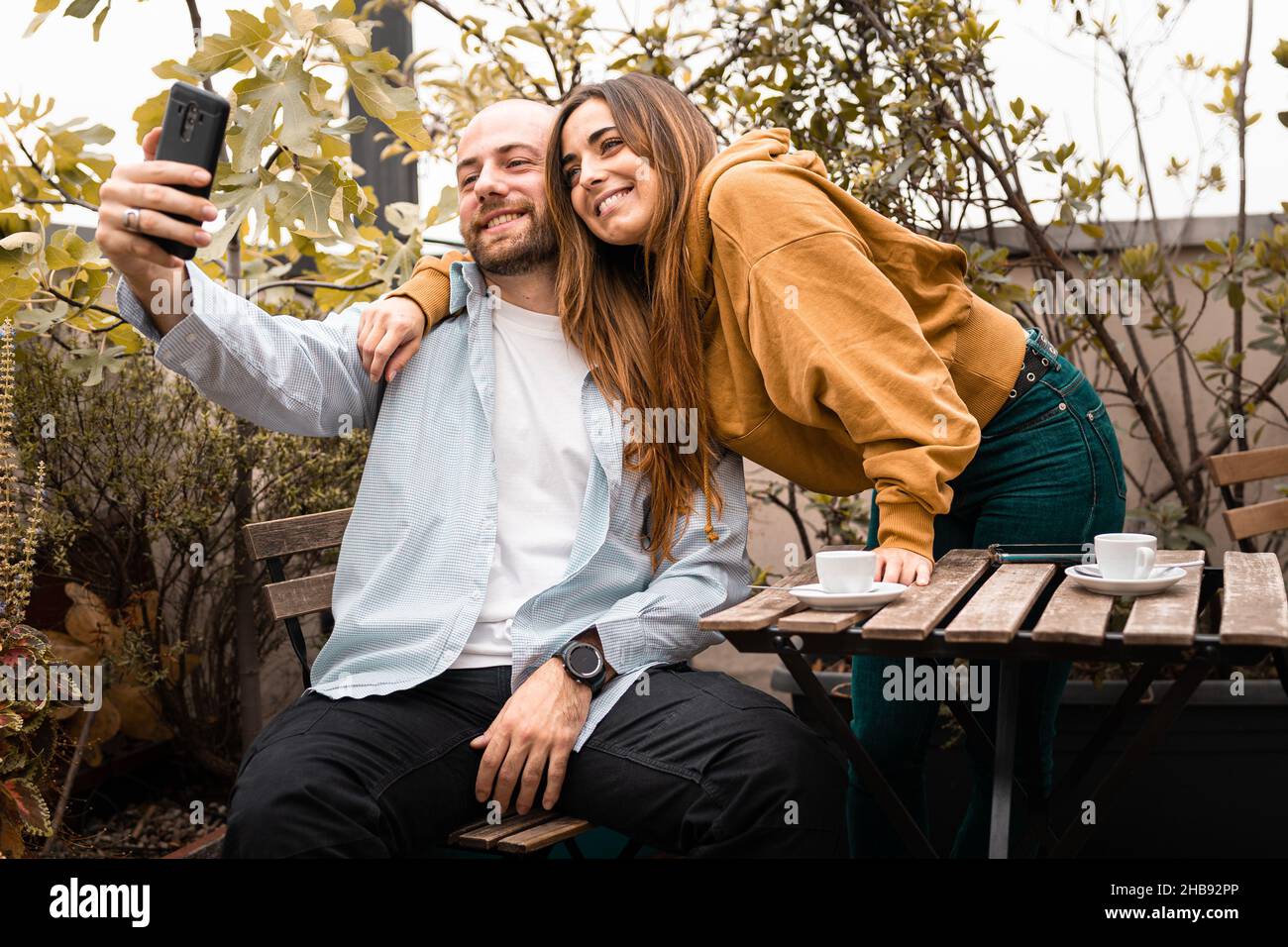 Couple of young people taking selfies in the terrace Stock Photo