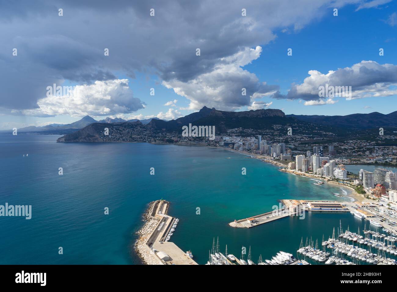 sailboats in the marina of Calpe and clouds on the Mediterranean coast in Spain Stock Photo