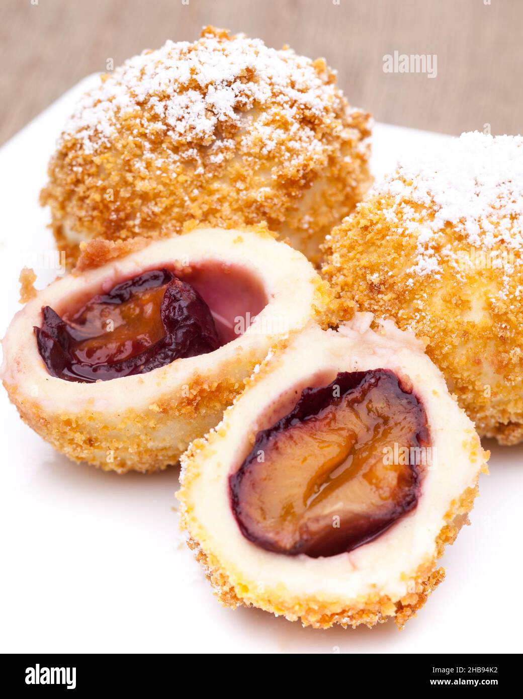 Plum dumplings on a white plate Stock Photo