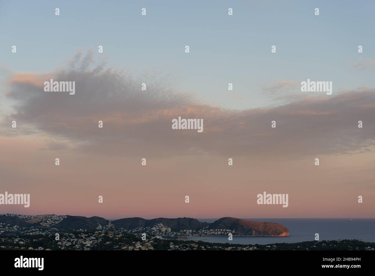 beautiful pale pink clouds at sunset on the mediterranean coast scenic sky background Stock Photo