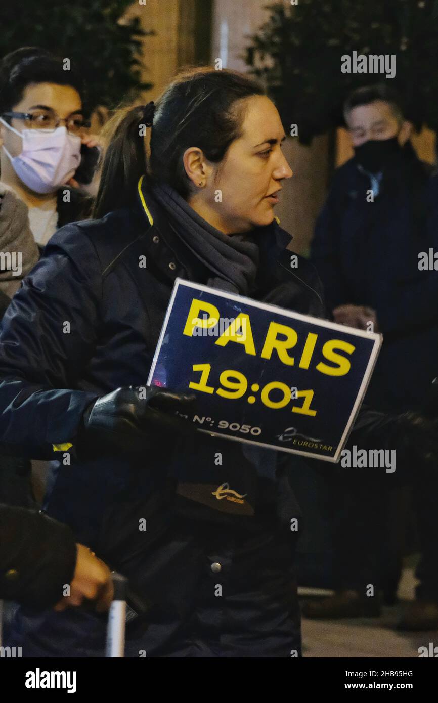 London, UK, 17th, Dec, 2021. A member of staff holds a sign indicating a queue for 19:01 service to Paris as thousands of travellers  leave London via St Pancras Eurostar services ahead of France's non-essential travel ban coming into force after 11pm GMT or at midnight Paris time. The restrictions are a move to stop the spread of Omicron infections as the UK records 93,045 coronavirus cases today. After midnight, non-citizens and non-residents must provide a 'compelling reason' in order to enter France from the UK. Credit: Eleventh Hour Photography/Alamy Live News Stock Photo